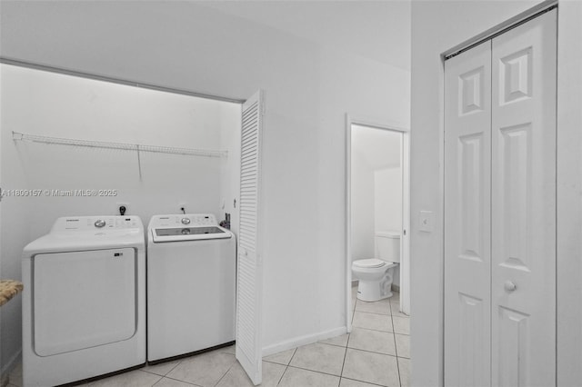 8206 SW 29th St Unit 104, Miramar, FL 33025 - laundry area featuring washer and dryer, light tile patterned floors, and baseboards