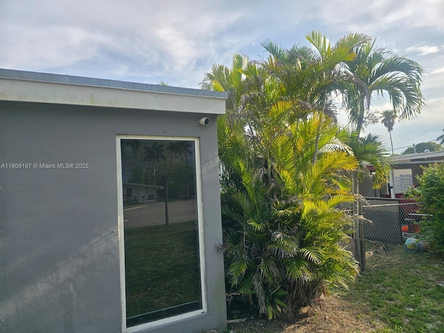 5812 NW 20th Ct, Margate, FL 33063 - view of property exterior with stucco siding and a security system