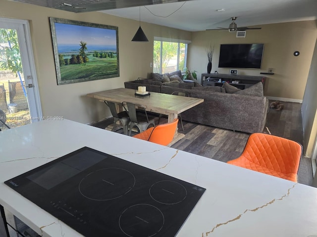 5812 NW 20th Ct, Margate, FL 33063 - dining area featuring wood finished floors, a ceiling fan, and baseboards