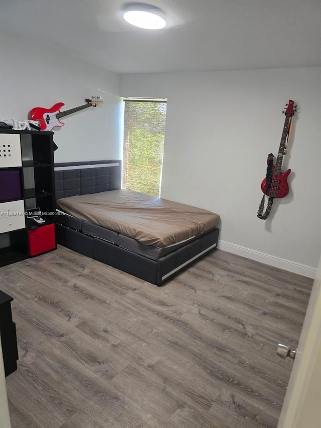 5812 NW 20th Ct, Margate, FL 33063 - bedroom featuring wood finished floors and baseboards