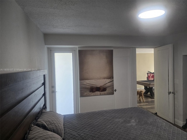 5812 NW 20th Ct, Margate, FL 33063 - bedroom with a textured ceiling and wood finished floors