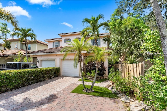 849 SW 11th Ct, Fort Lauderdale, FL 33315 - mediterranean / spanish house with stucco siding, decorative driveway, a tiled roof, and a garage