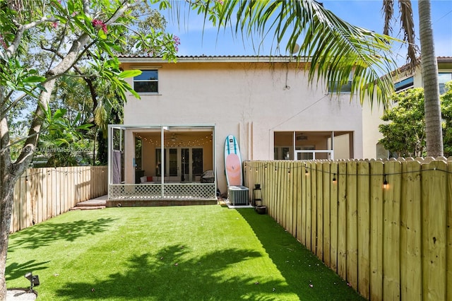 849 SW 11th Ct, Fort Lauderdale, FL 33315 - back of house featuring stucco siding, a sunroom, and central AC
