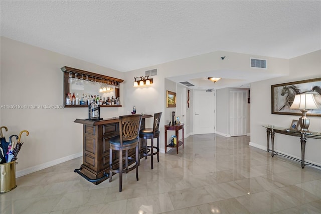 16445 Collins Ave Unit 2226, Sunny Isles Beach, FL 33160 - indoor bar featuring marble finish flooring, baseboards, and a textured ceiling