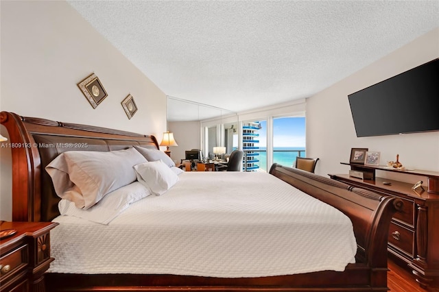 16445 Collins Ave Unit 2226, Sunny Isles Beach, FL 33160 - bedroom with a textured ceiling and dark wood finished floors