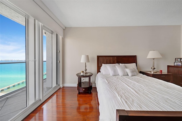 16445 Collins Ave Unit 2226, Sunny Isles Beach, FL 33160 - bedroom featuring wood finished floors, access to exterior, and baseboards
