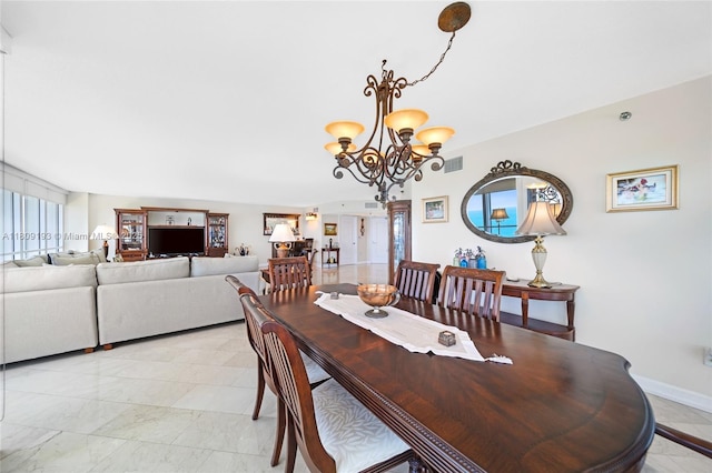16445 Collins Ave Unit 2226, Sunny Isles Beach, FL 33160 - dining space with a chandelier and baseboards