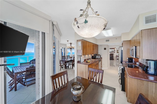 16445 Collins Ave Unit 2226, Sunny Isles Beach, FL 33160 - dining room with a chandelier and light tile patterned floors