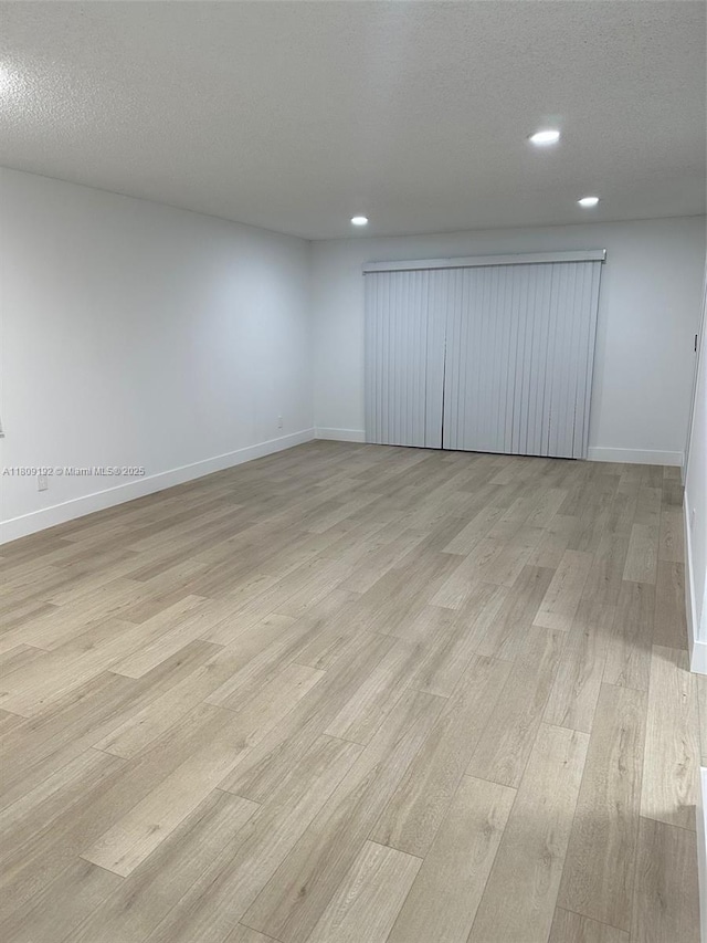 9201 Sunrise Lakes Blvd Unit 301, Sunrise, FL 33322 - empty room with light wood-type flooring, recessed lighting, baseboards, and a textured ceiling