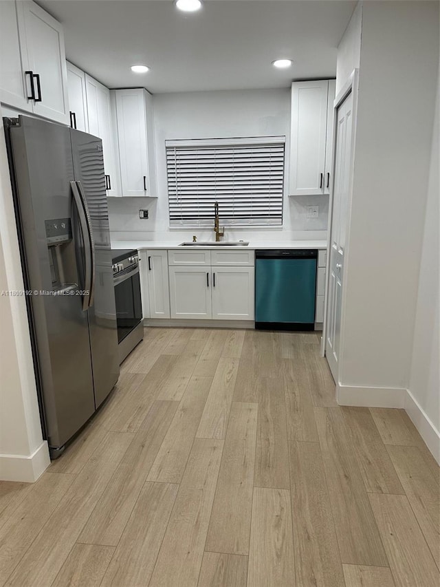 9201 Sunrise Lakes Blvd Unit 301, Sunrise, FL 33322 - kitchen featuring stainless steel appliances, a sink, light wood finished floors, white cabinetry, and recessed lighting