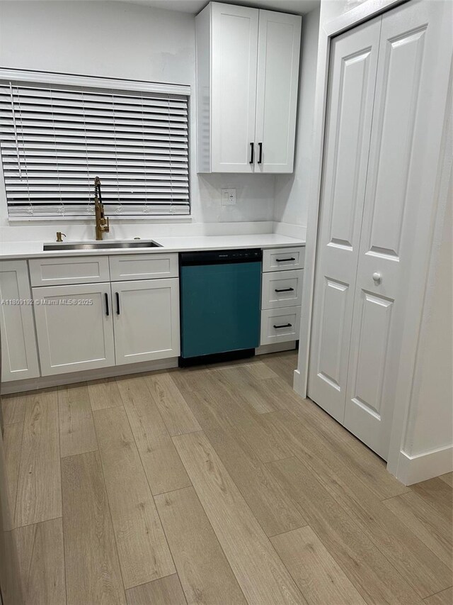 9201 Sunrise Lakes Blvd Unit 301, Sunrise, FL 33322 - kitchen featuring dishwashing machine, a sink, light wood-style flooring, light countertops, and white cabinets