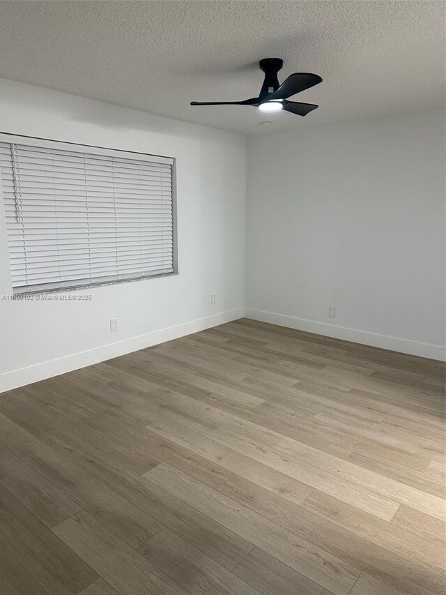 9201 Sunrise Lakes Blvd Unit 301, Sunrise, FL 33322 - spare room featuring wood finished floors, ceiling fan, a textured ceiling, and baseboards