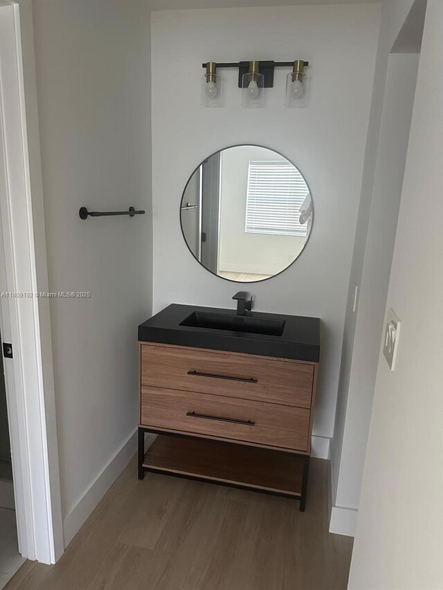 9201 Sunrise Lakes Blvd Unit 301, Sunrise, FL 33322 - bathroom featuring wood finished floors, vanity, and baseboards