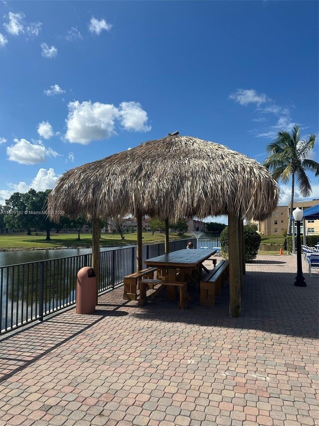 9201 Sunrise Lakes Blvd Unit 301, Sunrise, FL 33322 - view of patio / terrace featuring outdoor dining area and a water view