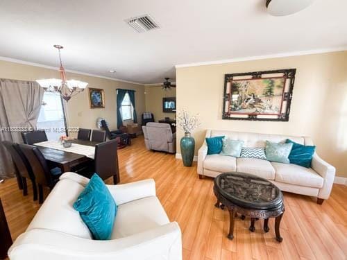 11321 SW 162nd Ter, Miami, FL 33157 - living area featuring crown molding, a chandelier, wood finished floors, and a ceiling fan
