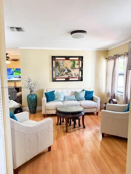 11321 SW 162nd Ter, Miami, FL 33157 - living area featuring light wood-style flooring, a ceiling fan, and crown molding