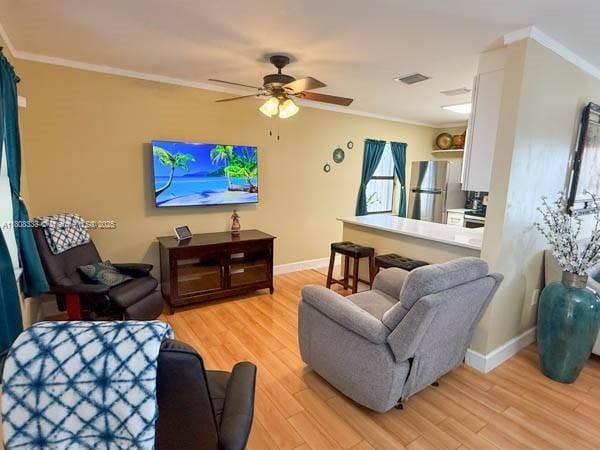 11321 SW 162nd Ter, Miami, FL 33157 - living area featuring light wood-style flooring, ornamental molding, ceiling fan, and baseboards