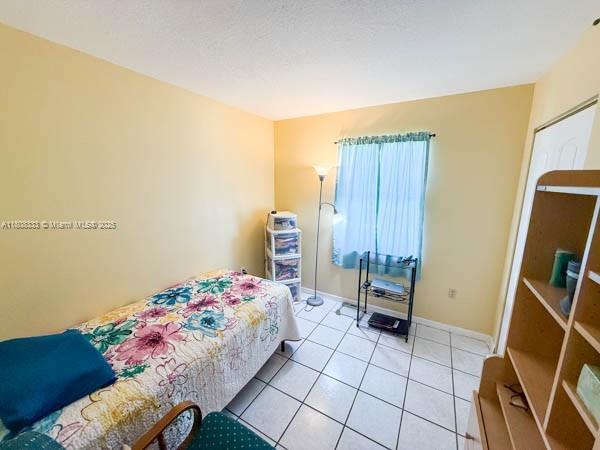 11321 SW 162nd Ter, Miami, FL 33157 - bedroom featuring light tile patterned floors and baseboards