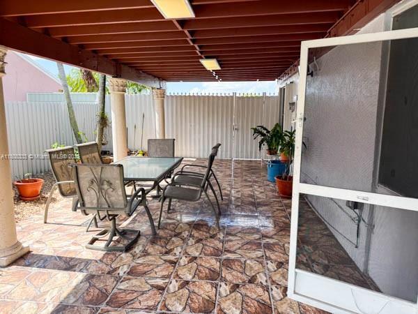 11321 SW 162nd Ter, Miami, FL 33157 - fenced backyard with outdoor dining area and a patio