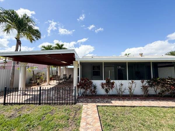 11321 SW 162nd Ter, Miami, FL 33157 - back of property with a patio area and a sunroom