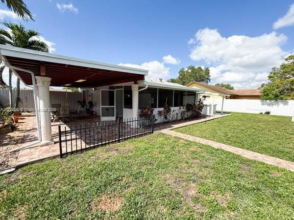 11321 SW 162nd Ter, Miami, FL 33157 - rear view of house with a sunroom and a patio