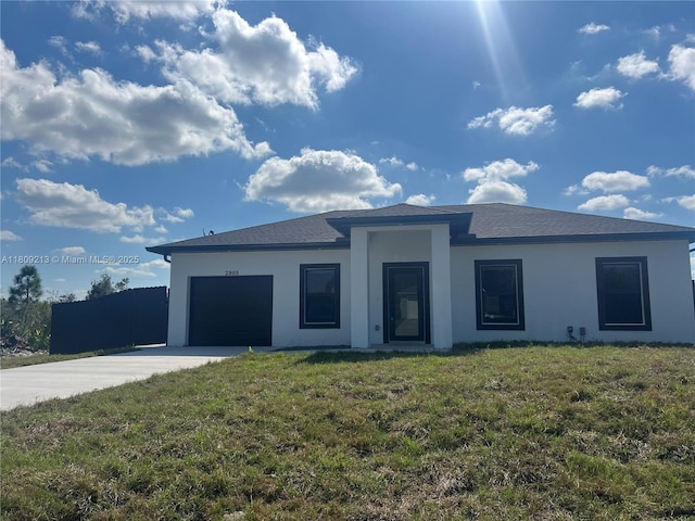 2903 W 64th St, Lehigh Acres, FL 33971 - prairie-style house with concrete driveway, stucco siding, an attached garage, and a front yard