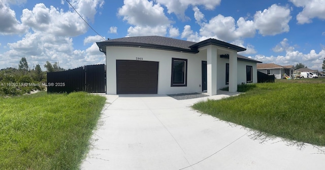 2903 W 64th St, Lehigh Acres, FL 33971 - view of front of home featuring a garage, concrete driveway, and stucco siding