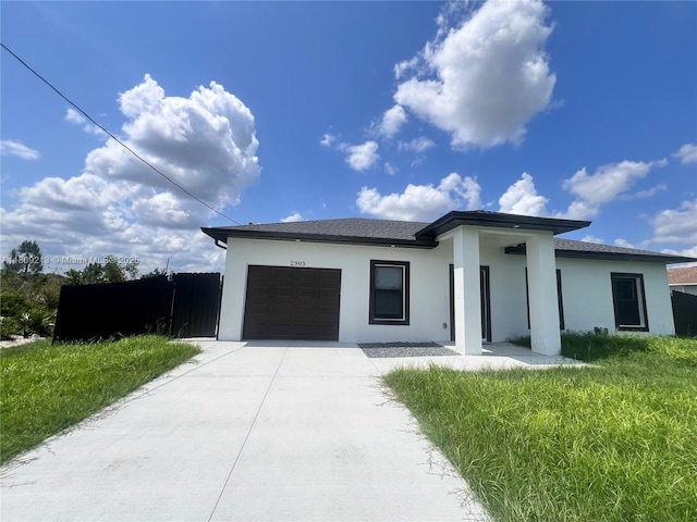 2903 W 64th St, Lehigh Acres, FL 33971 - prairie-style home featuring stucco siding, a garage, and concrete driveway