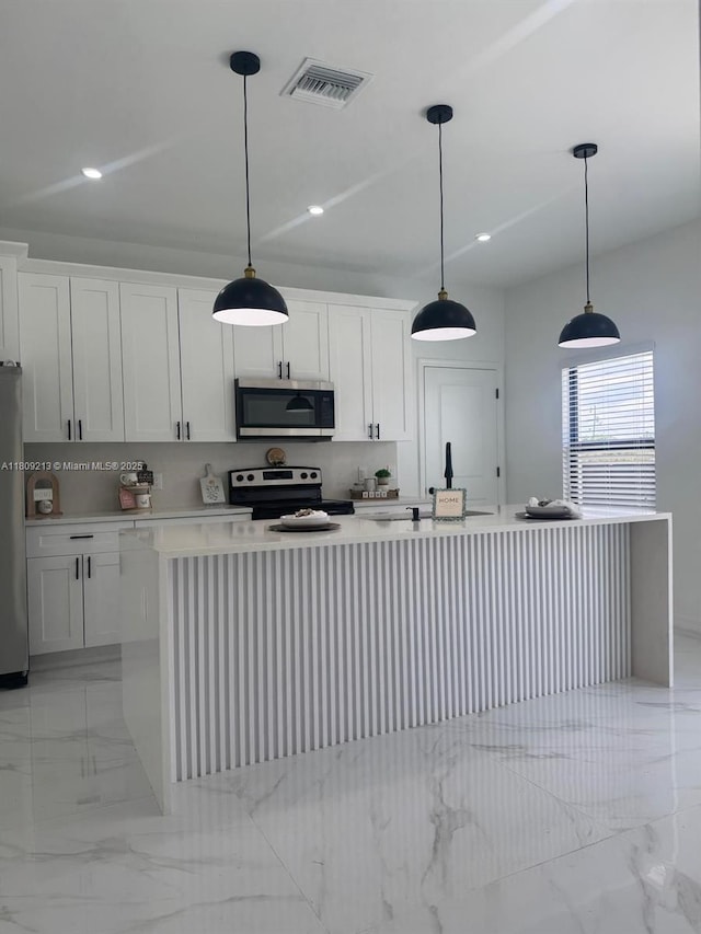 2903 W 64th St, Lehigh Acres, FL 33971 - kitchen featuring stainless steel appliances, light marble finish floors, light countertops, white cabinets, and recessed lighting