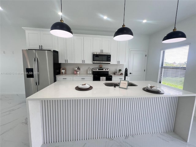 2903 W 64th St, Lehigh Acres, FL 33971 - kitchen featuring appliances with stainless steel finishes, a sink, an island with sink, light marble finish floors, and white cabinetry