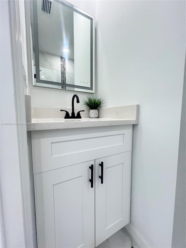 2903 W 64th St, Lehigh Acres, FL 33971 - bathroom featuring vanity, marble finish floors, and baseboards