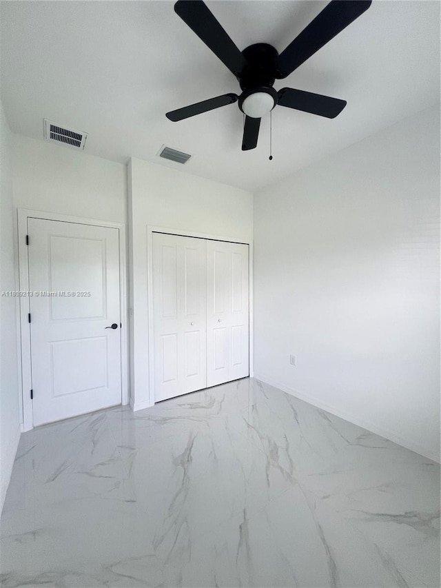 2903 W 64th St, Lehigh Acres, FL 33971 - unfurnished bedroom with a closet, marble finish floors, ceiling fan, and baseboards