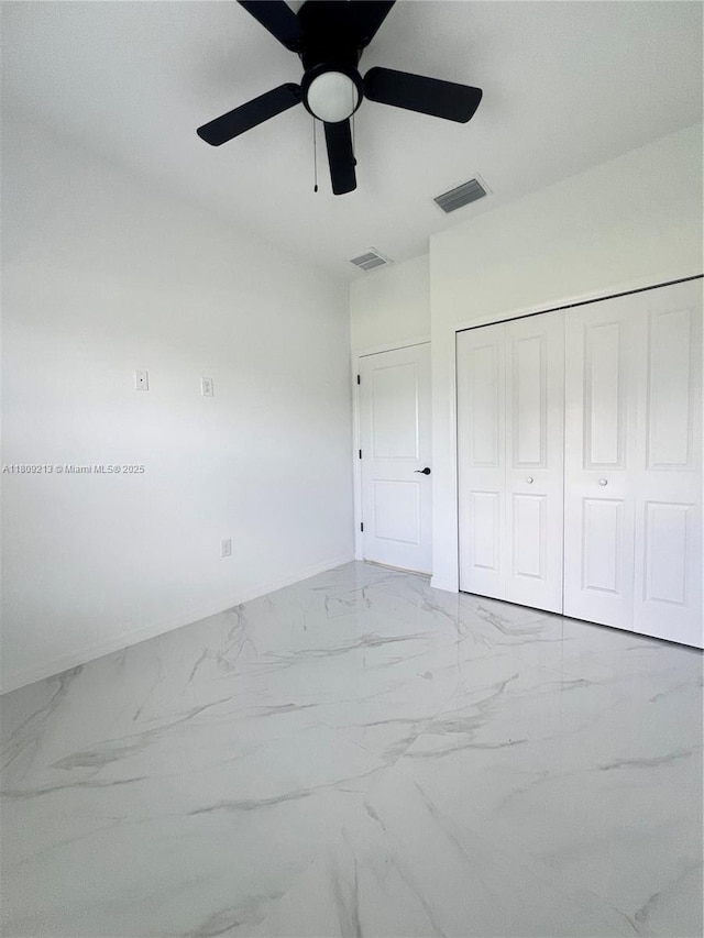 2903 W 64th St, Lehigh Acres, FL 33971 - unfurnished bedroom featuring marble finish flooring, a closet, and ceiling fan