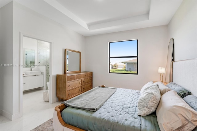 8106 Olive Ct, La Belle, FL 33935 - bedroom featuring a sink, a raised ceiling, and ensuite bath