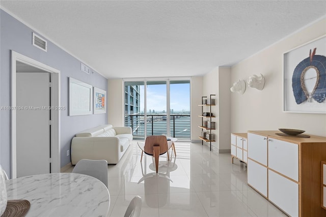325 S Biscayne Blvd Unit 3926, Miami, FL 33131 - living room with expansive windows, light tile patterned floors, a water view, a textured ceiling, and baseboards