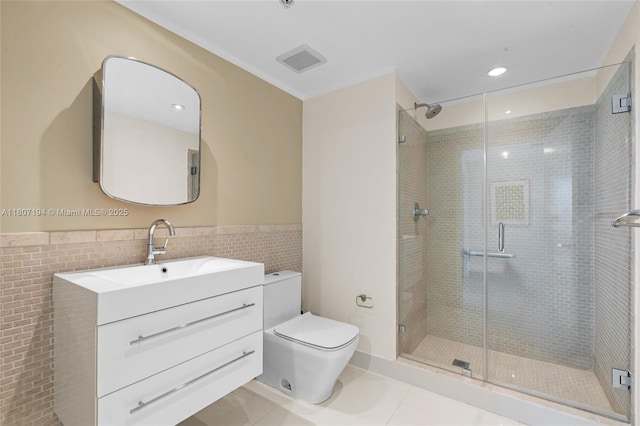 325 S Biscayne Blvd Unit 3926, Miami, FL 33131 - bathroom featuring vanity, toilet, tile walls, a shower stall, and a wainscoted wall