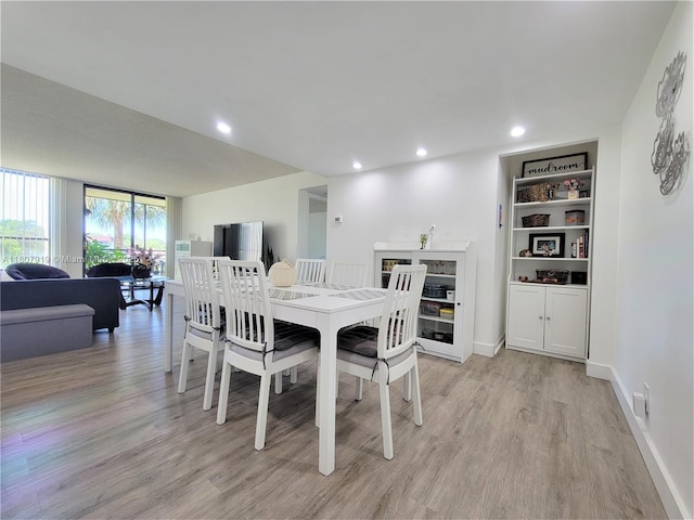 7950 W Mcnab Rd Unit 214, Tamarac, FL 33321 - dining room with light wood finished floors, baseboards, recessed lighting, and built in shelves