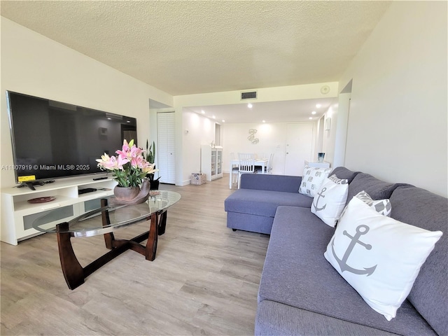 7950 W Mcnab Rd Unit 214, Tamarac, FL 33321 - living area with light wood-type flooring, a textured ceiling, and baseboards