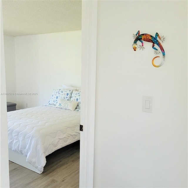 7950 W Mcnab Rd Unit 214, Tamarac, FL 33321 - bedroom with wood finished floors