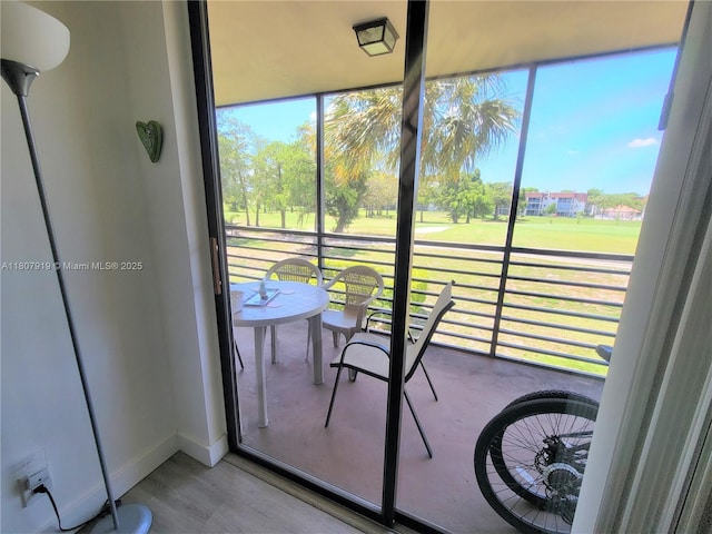 7950 W Mcnab Rd Unit 214, Tamarac, FL 33321 - sunroom / solarium with wood finished floors, baseboards, and golf course view