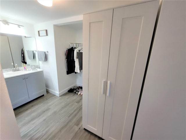 7950 W Mcnab Rd Unit 214, Tamarac, FL 33321 - full bath with vanity, wood finished floors, baseboards, and a spacious closet