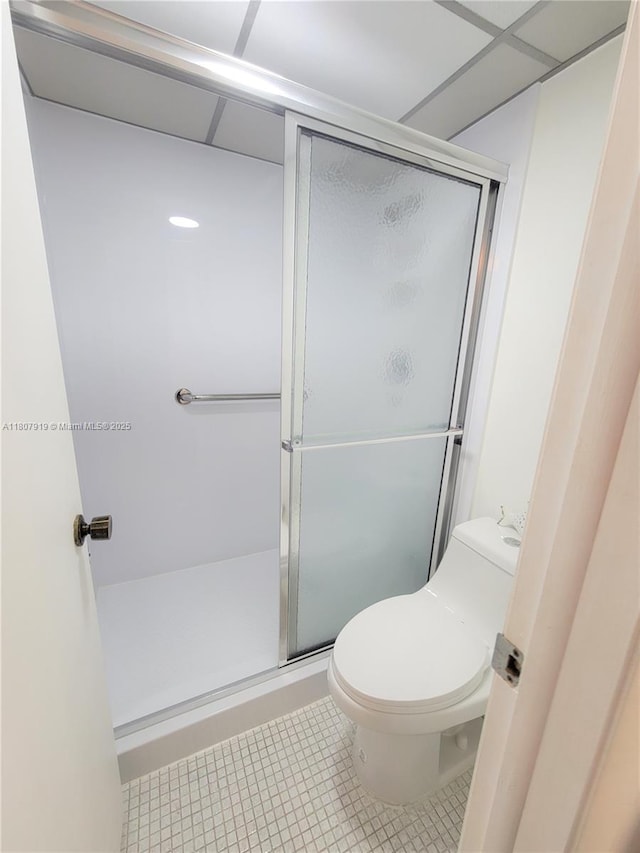 7950 W Mcnab Rd Unit 214, Tamarac, FL 33321 - bathroom featuring toilet, a stall shower, and tile patterned flooring