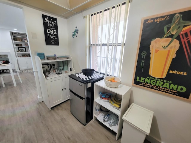 7950 W Mcnab Rd Unit 214, Tamarac, FL 33321 - kitchen featuring light wood-style floors and white cabinetry