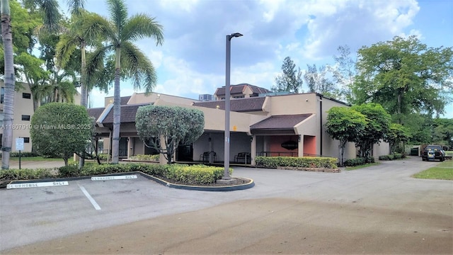 7950 W Mcnab Rd Unit 214, Tamarac, FL 33321 - view of building exterior featuring uncovered parking