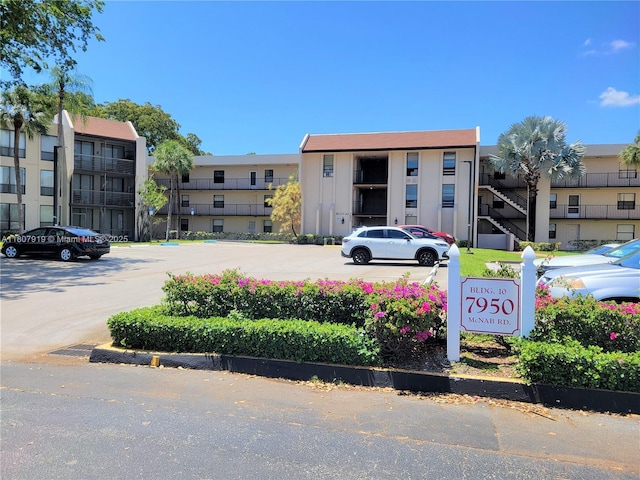 7950 W Mcnab Rd Unit 214, Tamarac, FL 33321 - view of apartment building / complex featuring uncovered parking