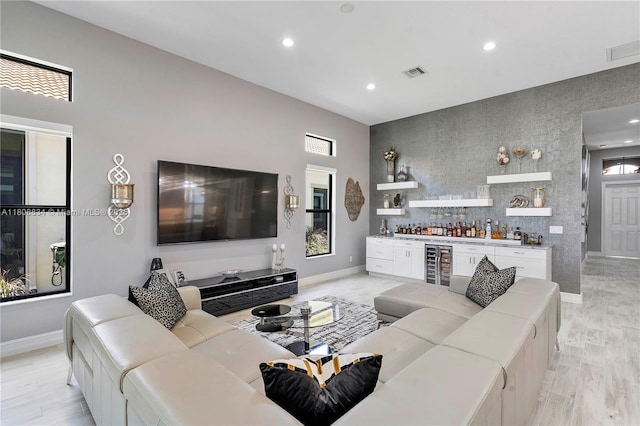 12065 N Kalmar Cir N, Parkland, FL 33076 - living area with a dry bar, baseboards, beverage cooler, recessed lighting, and light wood finished floors