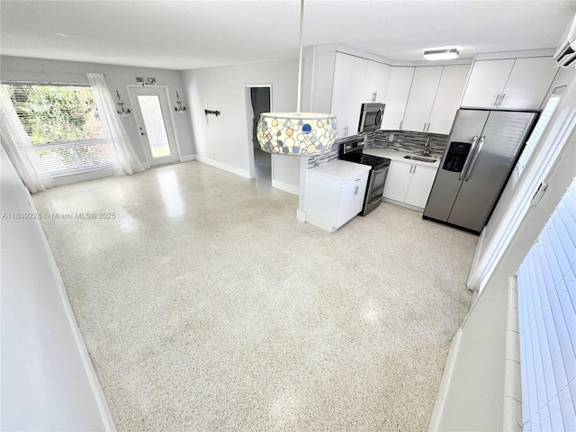 1601 SE 15th St Unit 1B, Fort Lauderdale, FL 33316 - kitchen featuring appliances with stainless steel finishes, a sink, white cabinetry, dark speckled floor, and light countertops