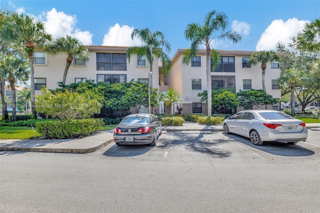 4350 NW 30th St Unit 233, Coconut Creek, FL 33066 - view of building exterior with uncovered parking