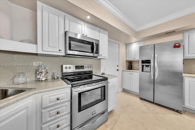 3111 N Ocean Dr Unit 904, Hollywood, FL 33019 - kitchen featuring appliances with stainless steel finishes, crown molding, light countertops, white cabinetry, and tasteful backsplash