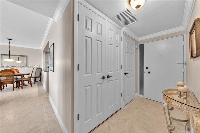 3111 N Ocean Dr Unit 904, Hollywood, FL 33019 - entrance foyer with light tile patterned flooring, ornamental molding, and baseboards
